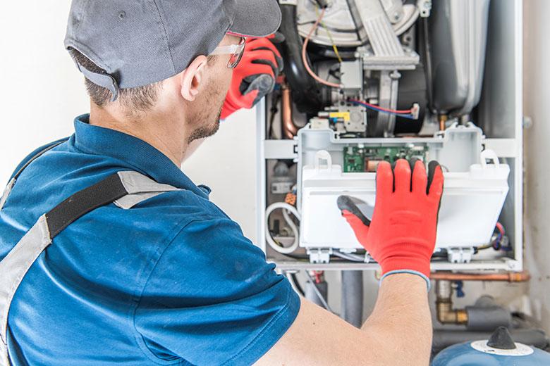 A man doing furnace repair in Ionia, MI