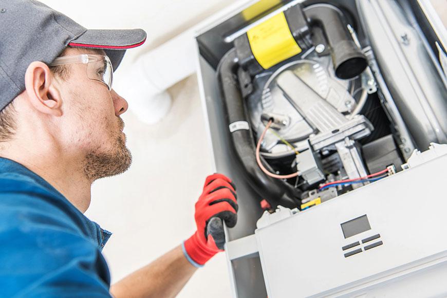 A HVAC specialist working doing furnace repair in Pewamo, MI