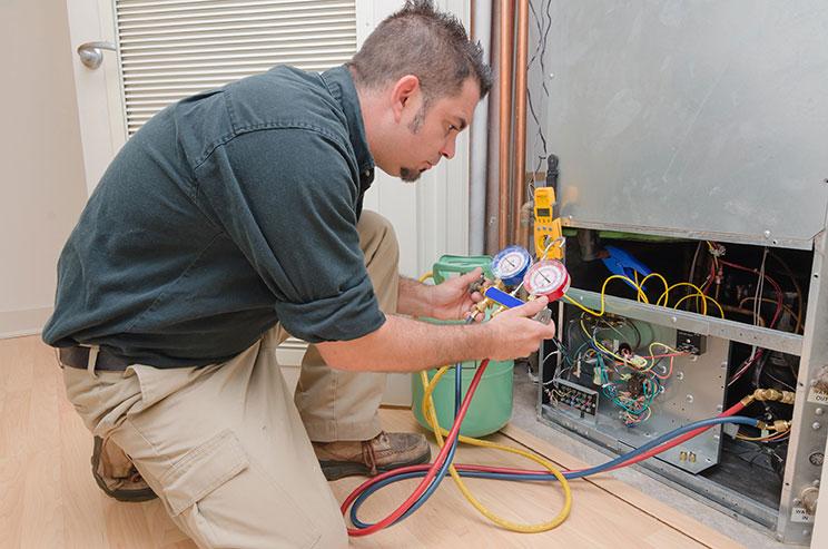 A heat pump being repaired in Pewamo, MI
